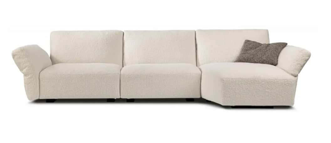 An L-shaped sectional sofa upholstered in a textured bouclé fabric, featuring a long, integrated cha… — 3D model