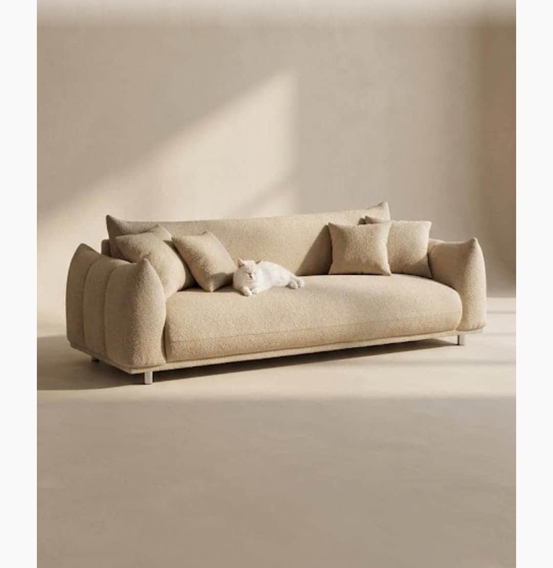 A contemporary sofa featuring a distinctive sculptural form, upholstered in a textured boucle fabric… — free GLTF 3D model