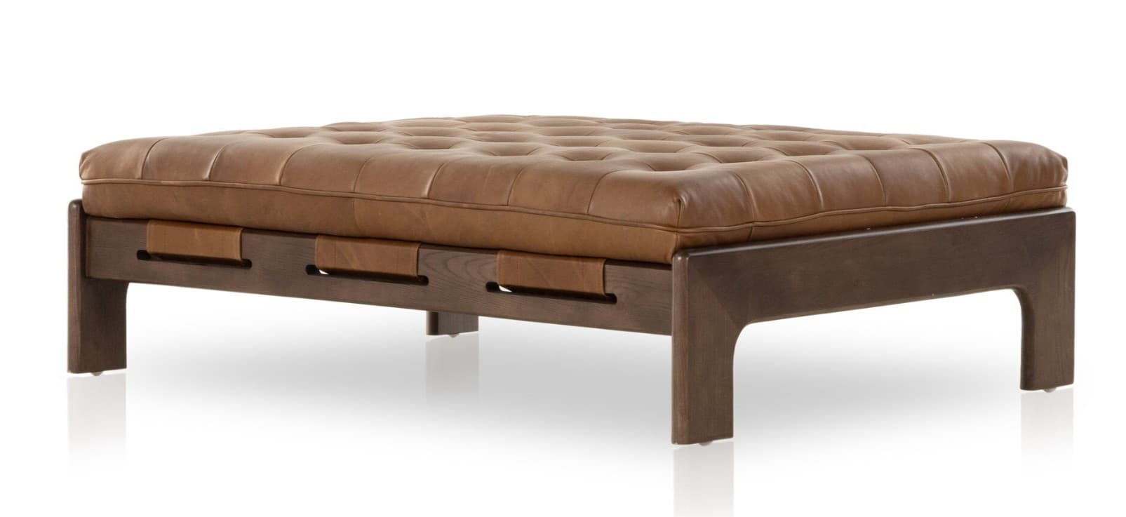 A rectangular tufted ottoman with a dark wood frame and brown leather upholstery. The frame features a modern design with angular legs and horizontal supports. Leather straps are integrated into the frame to hold the cushion in place. The cushion is deeply tufted with visible stitching. — 3D model