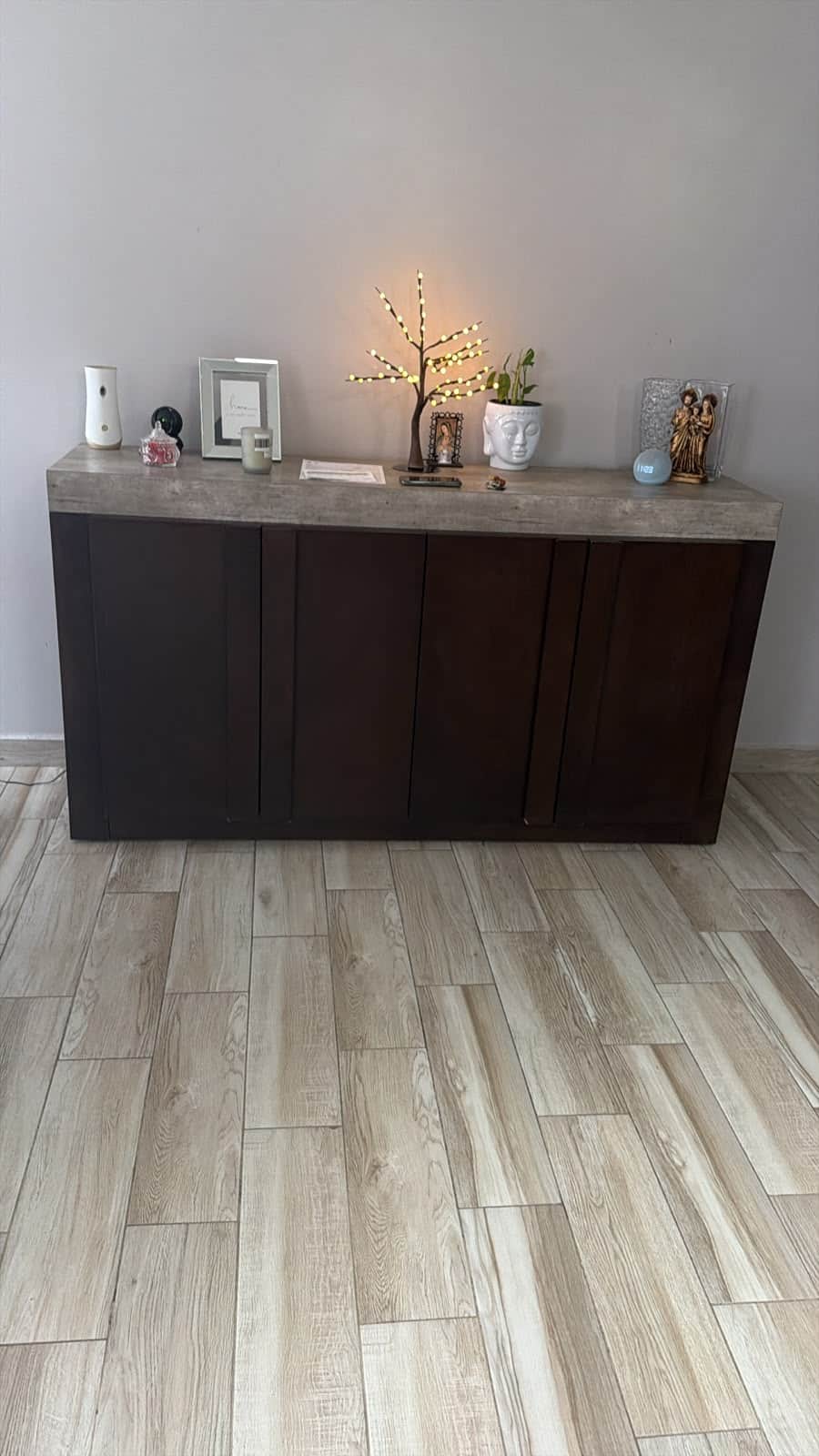 A modern, rectangular sideboard featuring a dark brown wood cabinet body and a substantial grey conc… — 3D model