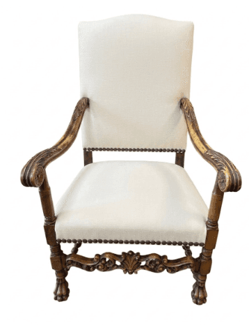 An ornate, antique-style armchair featuring dark carved wood and cream-colored upholstered seat and… — free OBJ 3D model