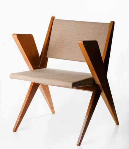A wooden armchair with a striking geometric design. The frame features an X-shaped leg structure and… — free STL 3D model