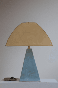 A modern table lamp featuring a pyramidal concrete base and a distinctive arched fabric shade. The d… — 3D model