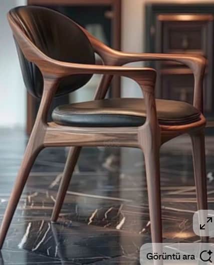 A contemporary armchair crafted from dark walnut wood, featuring a curved frame with integrated armr… — 3D model