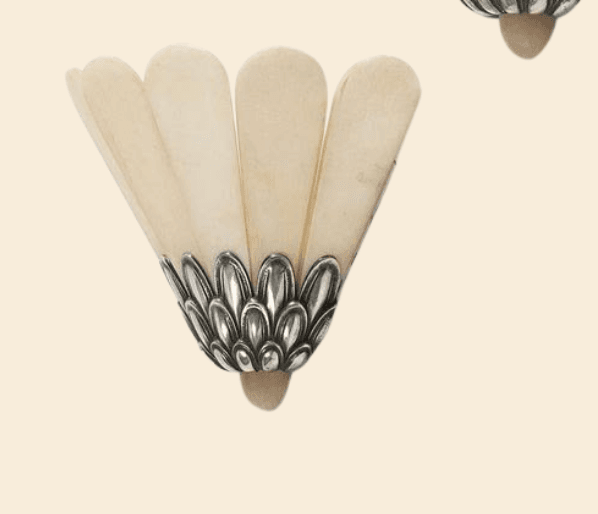 An Art Deco-style wall sconce featuring a fan-shaped shade composed of multiple translucent, off-white panels, likely alabaster. The shade is supported by an ornate cast metal base with a scalloped, leaf-like design and an antiqued silver or pewter finish. The fixture is designed for wall mounting. — 3D model