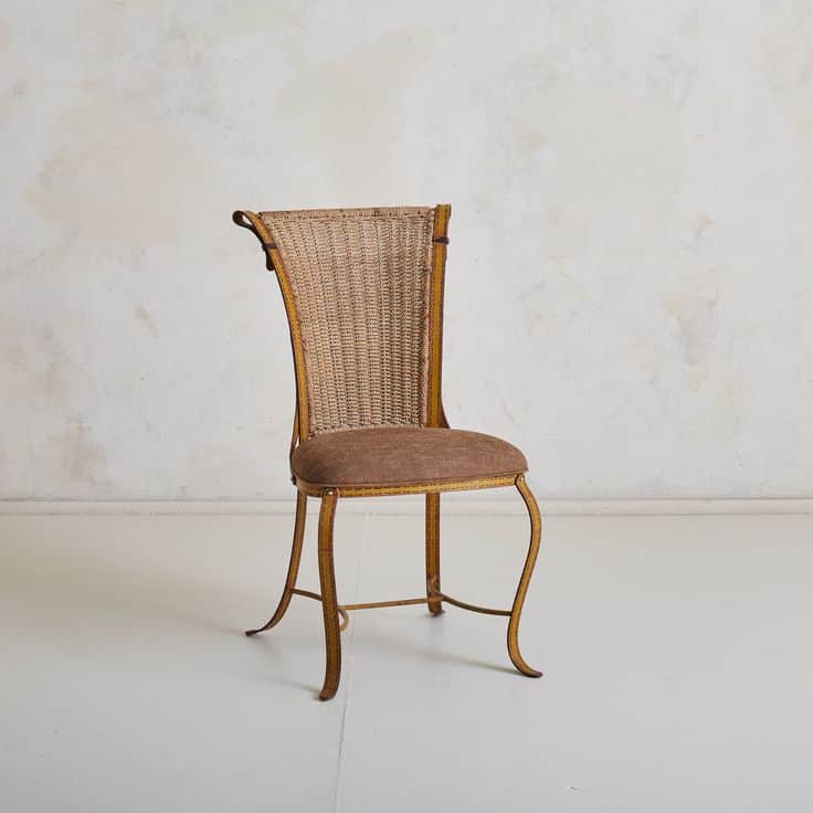 A cane-back chair with a cushioned seat and a decorative, curved leg structure. The backrest feature… — free GLTF 3D model