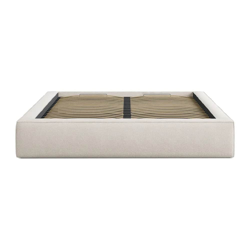 A minimalist, upholstered platform bed frame featuring a light beige, textured fabric. The frame has… — free BLEND 3D model