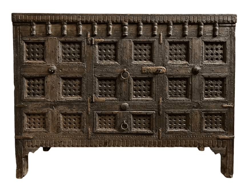 An antique, heavily carved wooden storage cabinet featuring multiple paneled doors with intricate perforated details, adorned with rustic metal hardware, and finished with a distressed, aged patina. — 3D model