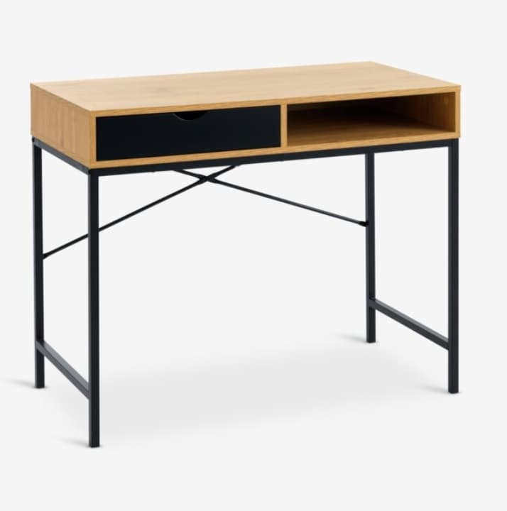 A modern writing desk featuring a light-toned wooden tabletop with an integrated storage unit, which includes a single black-fronted drawer and an open cubby. The desktop rests on a slender black metal frame with X-shaped crossbars for stability. — 3D model