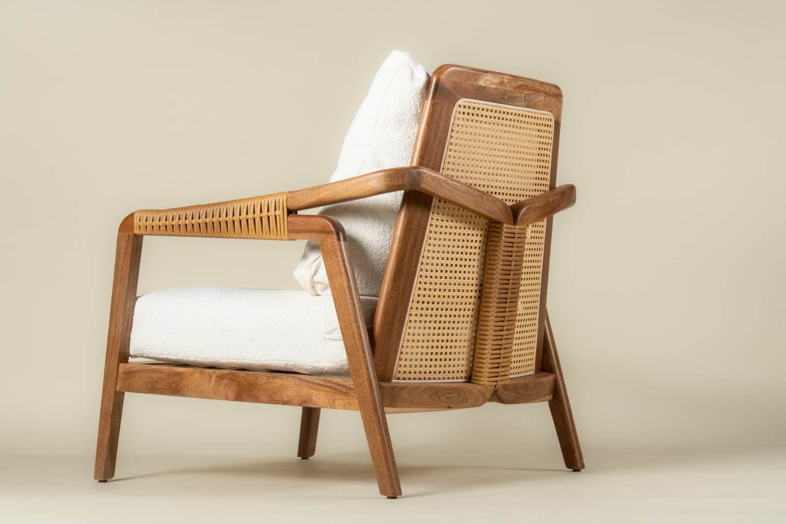 A wooden armchair with woven cane back and armrests. The chair has a plush white seat cushion and a… — free OBJ 3D model