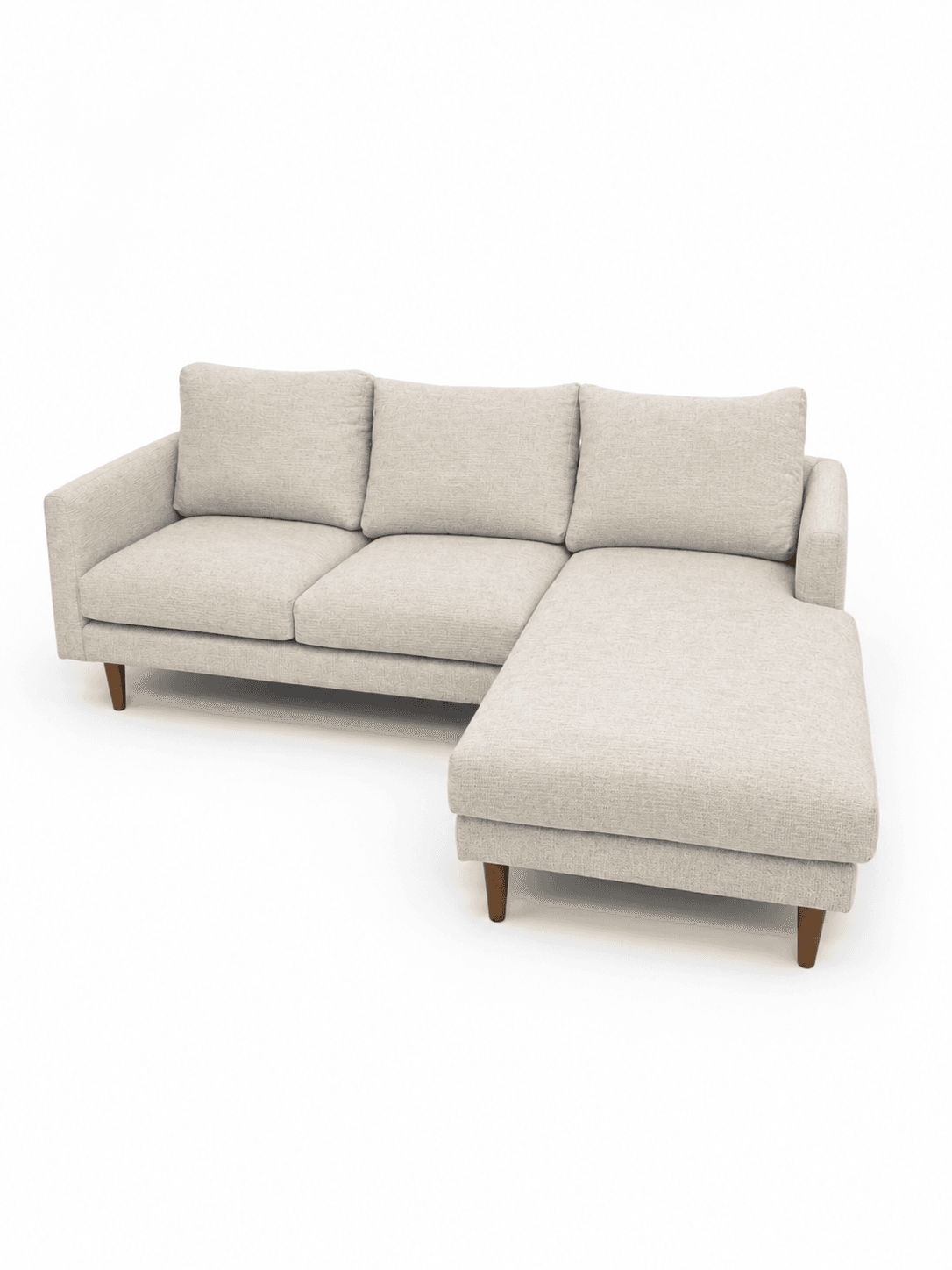 A contemporary sectional sofa upholstered in a light, textured beige fabric, featuring an integrated right-facing chaise lounge. The sofa has a clean-lined design with straight track arms, loose back cushions, and tapered wooden legs. — 3D model