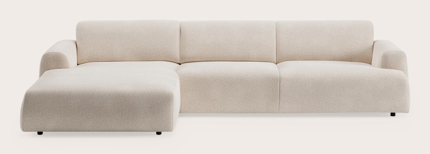A modern sectional sofa with a chaise lounge. The sofa features clean lines, a low profile, and upholstered arms that curve gently outwards. The seating and back cushions are integrated, providing a cohesive look. The fabric appears to be a textured weave. — 3D model