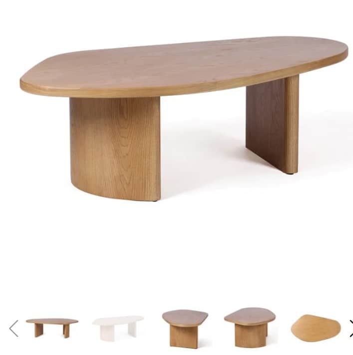 A light-colored wooden coffee table featuring an organic, kidney-bean-shaped tabletop supported by t… — 3D model