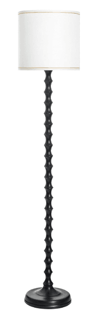 A floor lamp with a dark, segmented, faux bamboo-style stem and a white drum shade with thin gold trim. The base is round and flared. — 3D model
