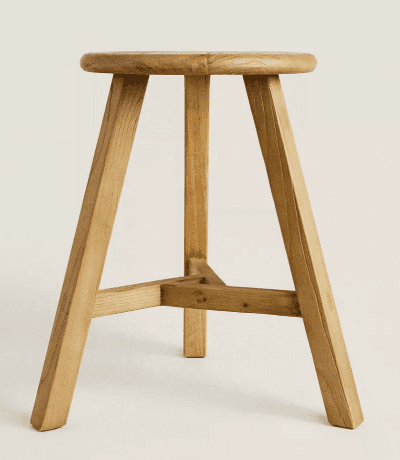 A three-legged wooden stool with a round seat and splayed legs. The legs are joined by a triangular… — 3D model