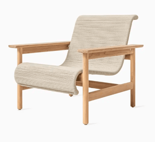 A modern armchair with a curved, woven seat and backrest, supported by a light-colored wooden frame. The frame features four legs, armrests, and a horizontal support connecting the front legs. The seat and back are constructed from tightly woven cord or rope in a neutral tone, creating a textured surface with visible horizontal lines. — 3D model