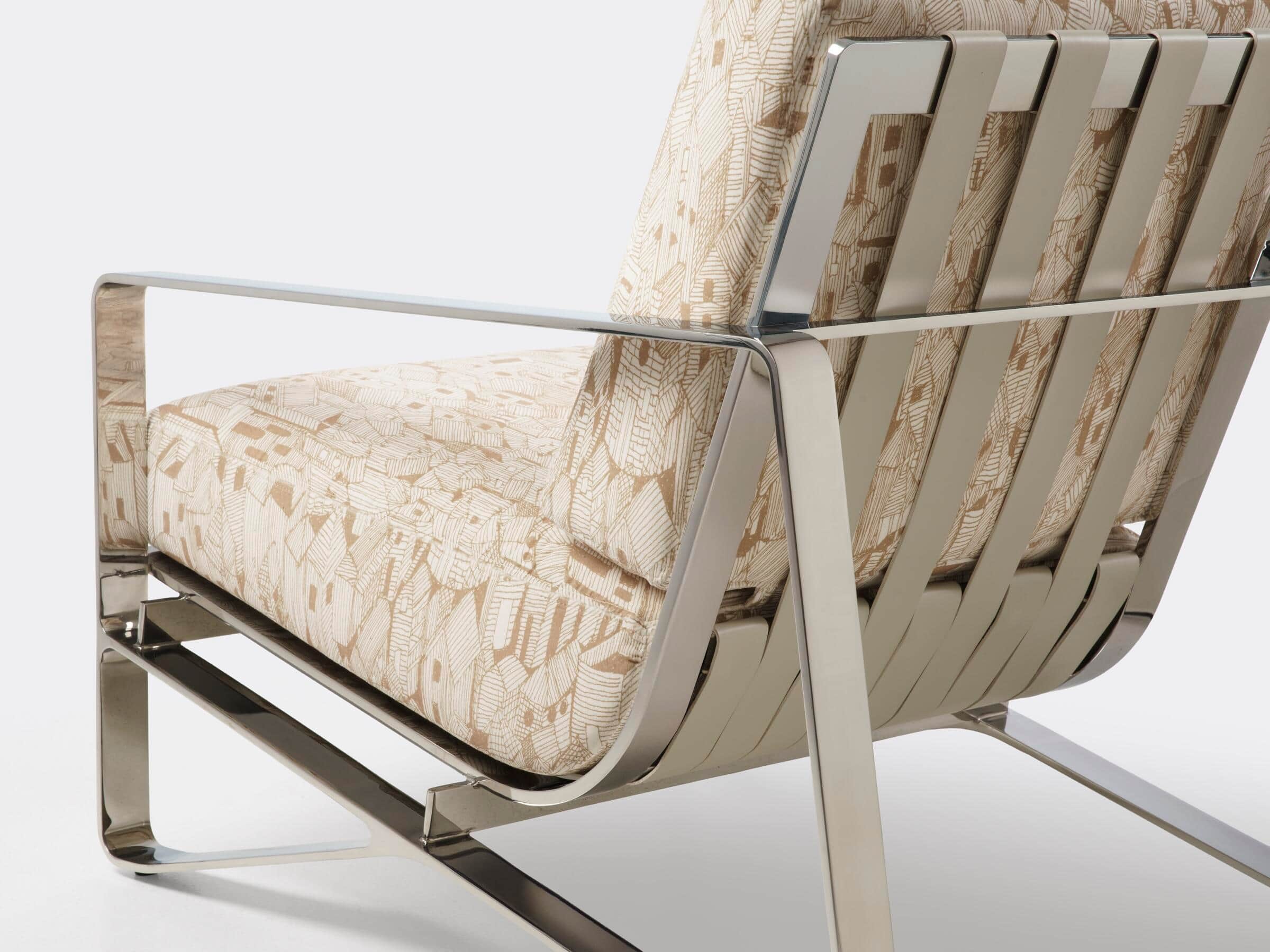 A modern lounge chair featuring a polished metal frame with integrated armrests and supportive back… — 3D model