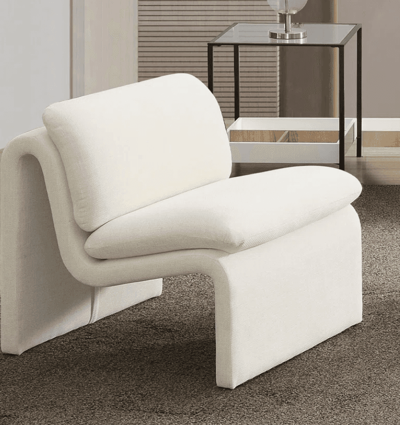 A contemporary armchair with a unique, sculptural design. It features a continuous, curved form that creates the seat, backrest, and armrests. The upholstery is a textured, light-colored fabric. The armchair appears to be a single, cohesive unit with no visible separate legs. — 3D model