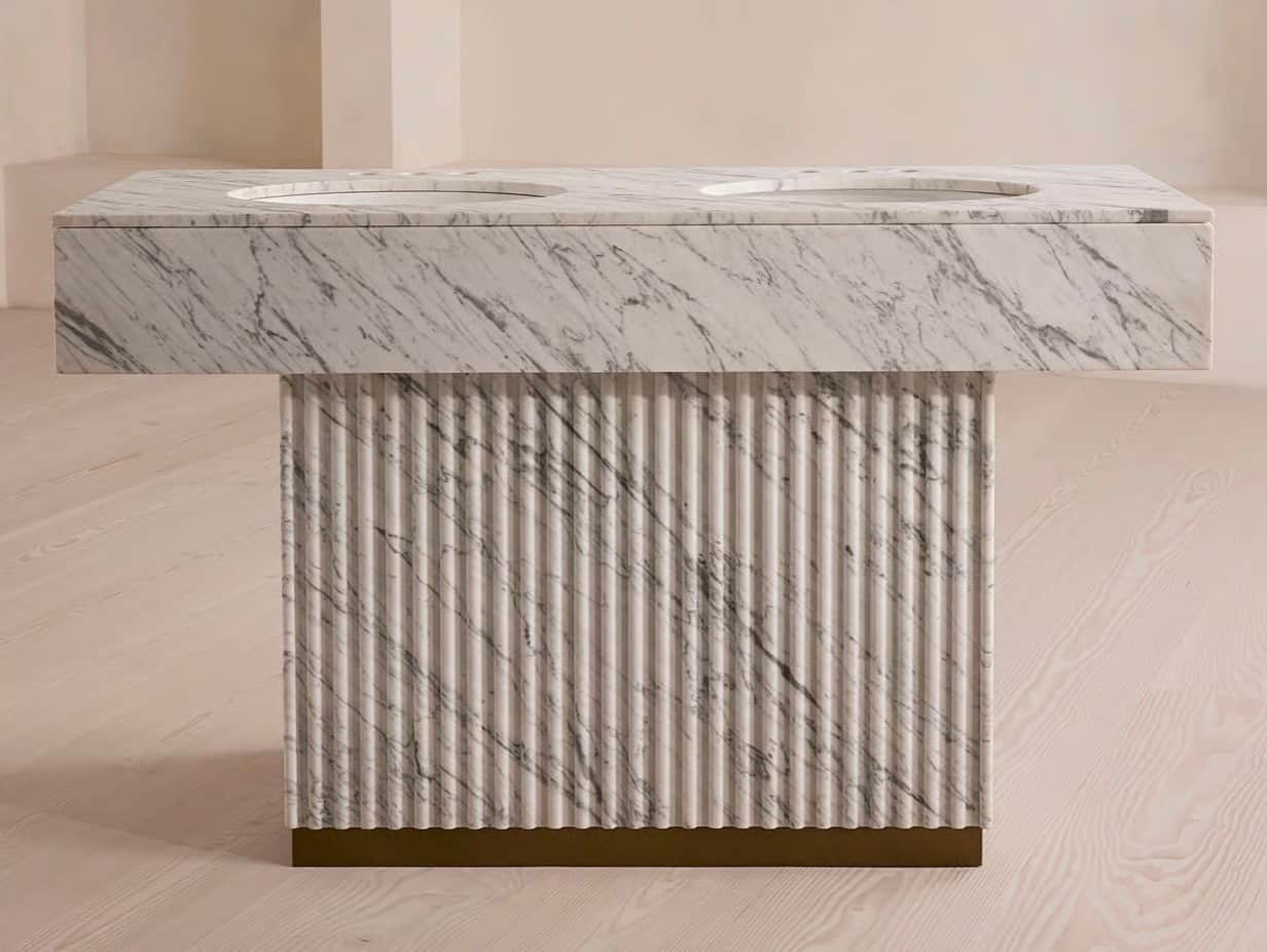 A double vanity with a marble top featuring two integrated sinks. The base is fluted and appears to… — 3D model