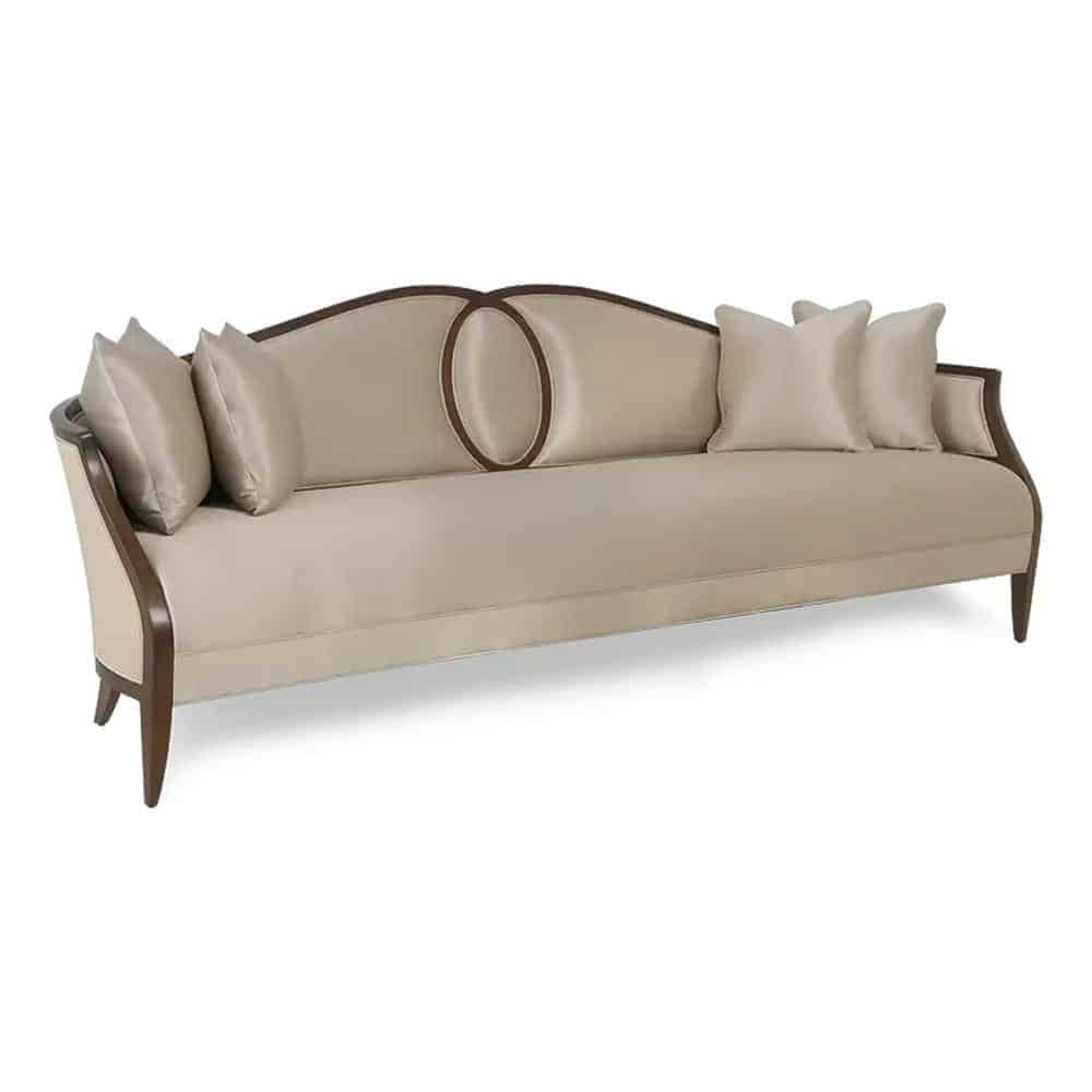 A long, upholstered sofa with a curved backrest. The sofa features wooden trim along the edges of th… — 3D model