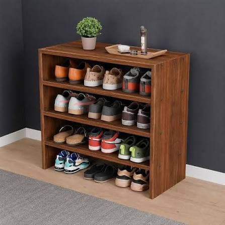 A compact, three-tier open shelving unit featuring a medium brown wood-look laminate finish. The unit has a simple, rectangular form with flat top, bottom, and side panels, and three equally spaced internal shelves. The construction appears to be engineered wood or particle board with visible screws on the exterior side panels, suggesting a flat-pack or modular design. The base is formed by the extended side panels, providing a low-profile stand. Its dimensions suggest it is suitable for small spaces or as an auxiliary storage piece. — 3D model