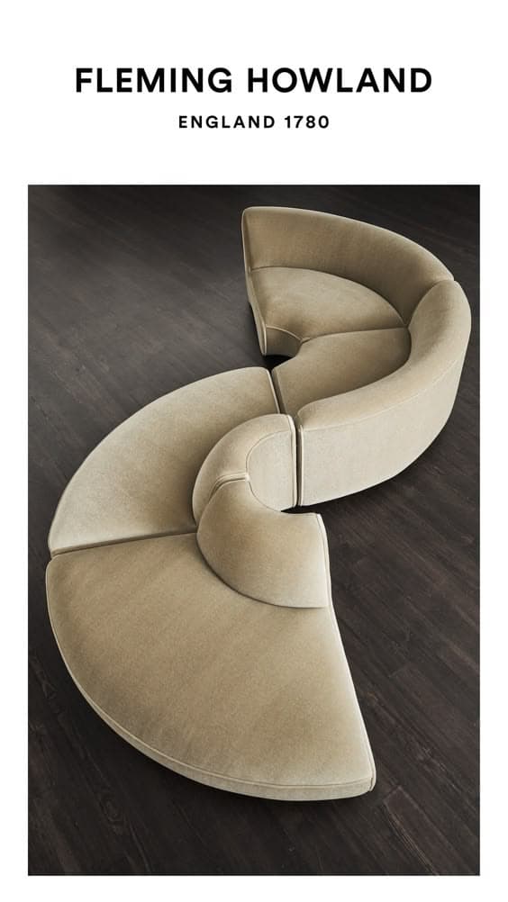 A large, contemporary modular sectional sofa composed of multiple curved segments, upholstered in a light greige velvet-like fabric. The units are arranged to form an elegant serpentine or S-shaped configuration, showcasing a smooth, continuous back and seat design. — 3D model