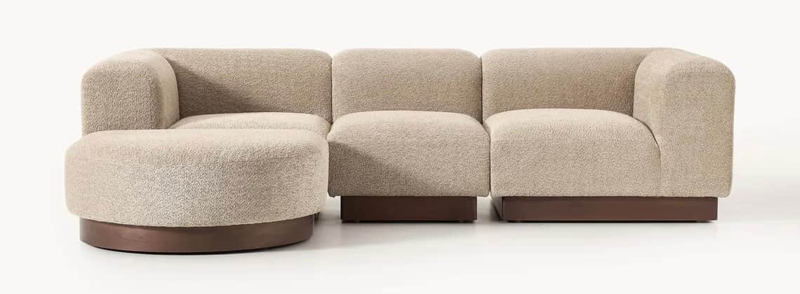 A contemporary modular sectional sofa with light beige bouclé upholstery and dark wood bases, featur… — 3D model