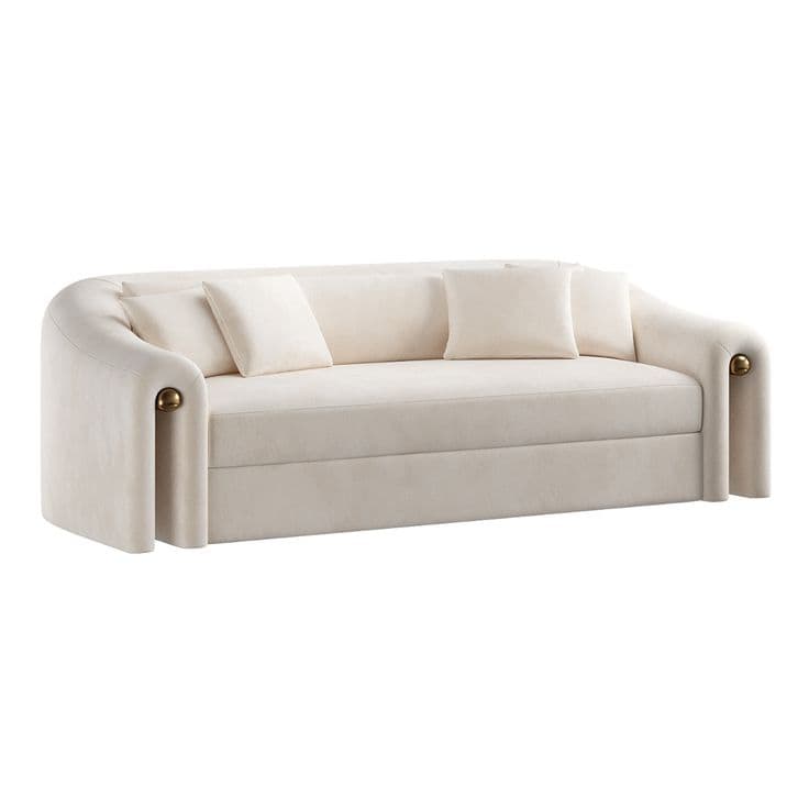 A contemporary upholstered sofa featuring a distinctive curvilinear form with rounded armrests and back, upholstered in a light cream-colored velvet, and accented with spherical brass-toned elements on the sides. It comes with several matching throw pillows. — 3D model