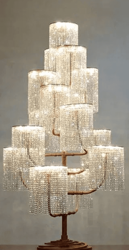 A tall, ornate floor lamp featuring a tree-like metal frame with a bronze or copper-toned finish, su… — 3D model