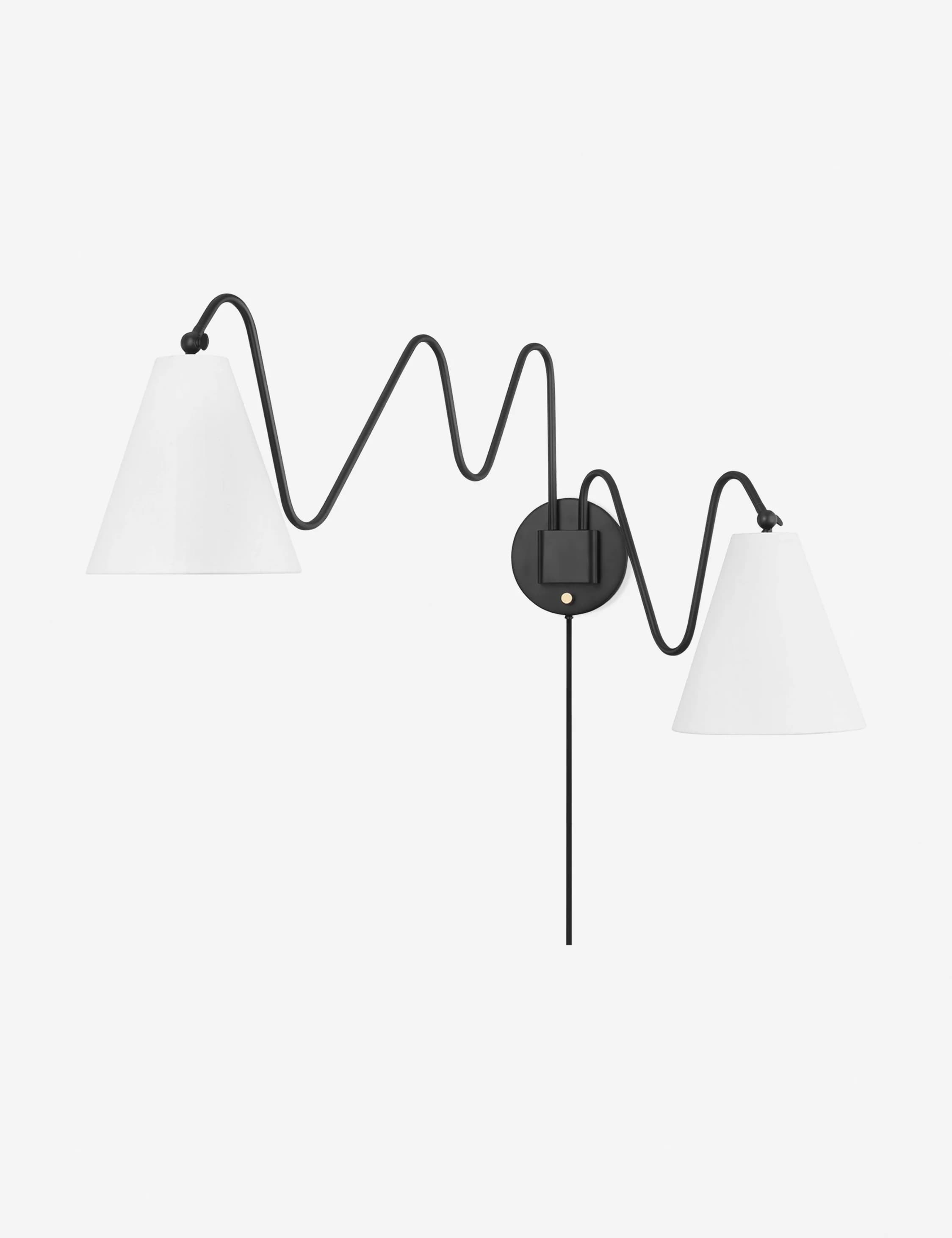 A double-headed wall sconce featuring a black, sinuous metal arm that extends from a circular black mounting plate. Each arm terminates in a conical, white lampshade. A black cord extends downwards from the mounting plate. — 3D model