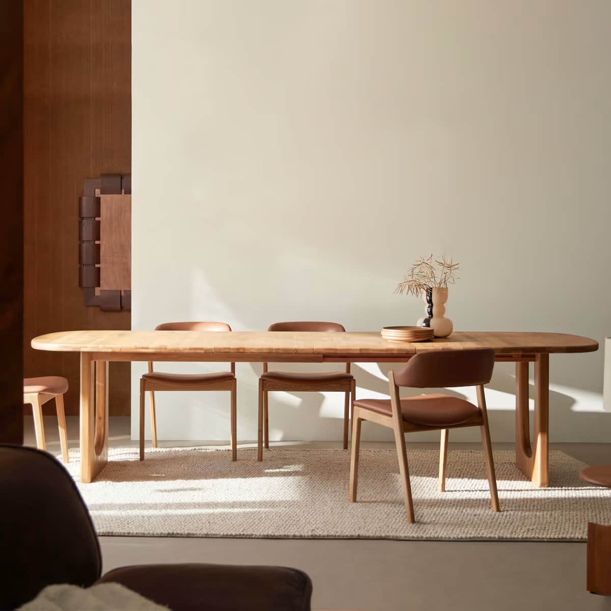 A minimalist, modern dining table constructed from light-toned wood, likely oak, featuring an extend… — 3D model