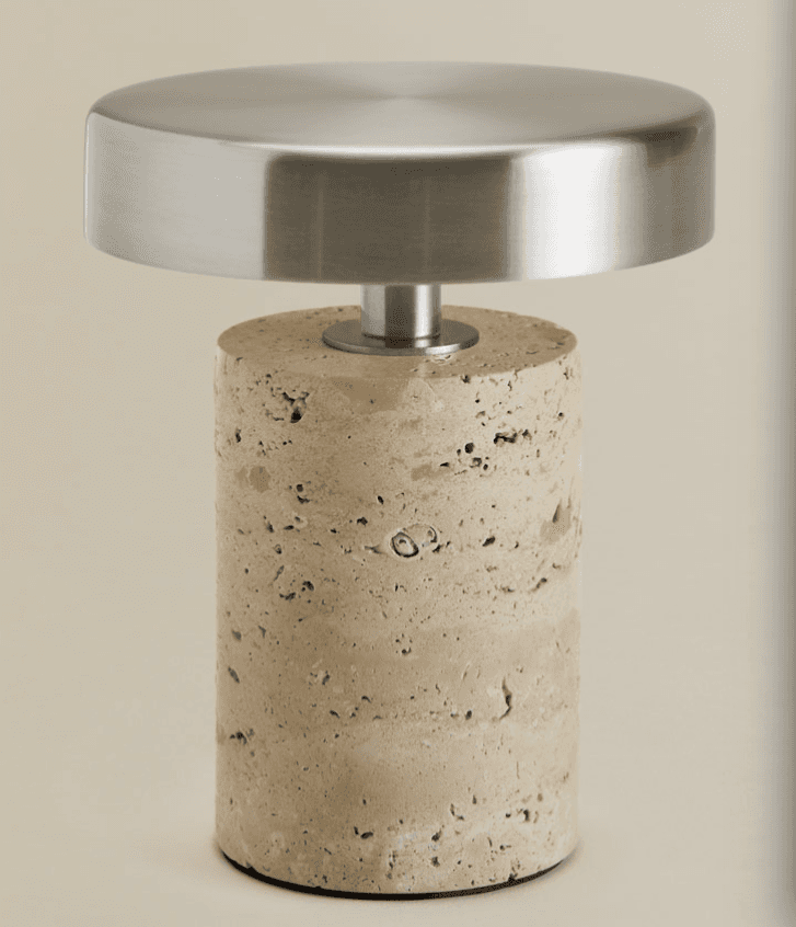 A compact table lamp featuring a cylindrical base crafted from light-colored, porous travertine ston… — 3D model
