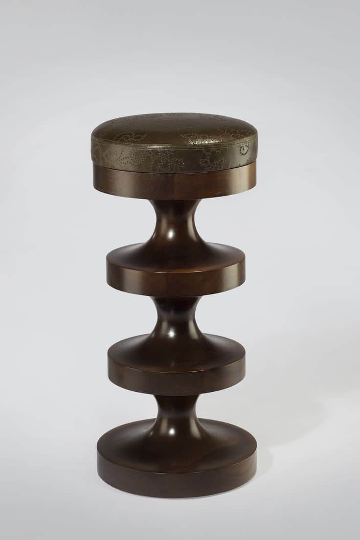 A wooden stool with a padded, upholstered top. The base of the stool is constructed from dark wood,… — 3D model