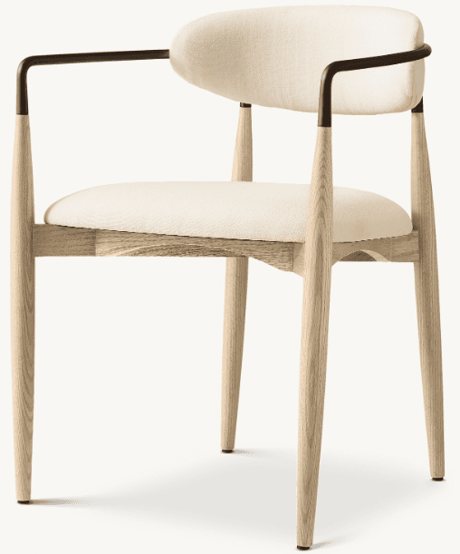 A modern armchair with a wooden frame and upholstered seat and back. The chair features tapered wooden legs and armrests that curve inwards, supporting a dark metal frame for the armrests. The seat and back are upholstered in a light-colored, textured fabric. — 3D model