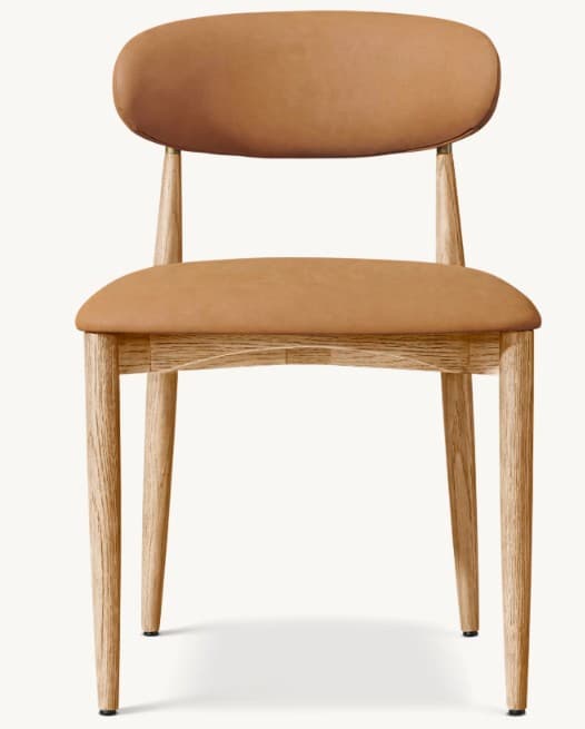 A contemporary dining chair featuring a light oak wood frame and light brown upholstered seat and backrest. The design is minimalist with tapered legs and gently curved padded elements. — 3D model