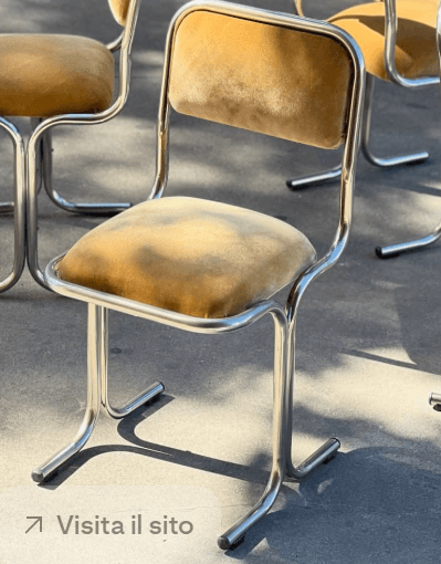 A vintage-inspired cantilever chair featuring a continuous tubular metal frame and separate upholstered seat and back pads. The frame is polished metal, likely chrome-plated steel, forming a sled base. The upholstery is a mustard yellow fabric, possibly velour or velvet, providing a soft contrast to the rigid frame. — 3D model