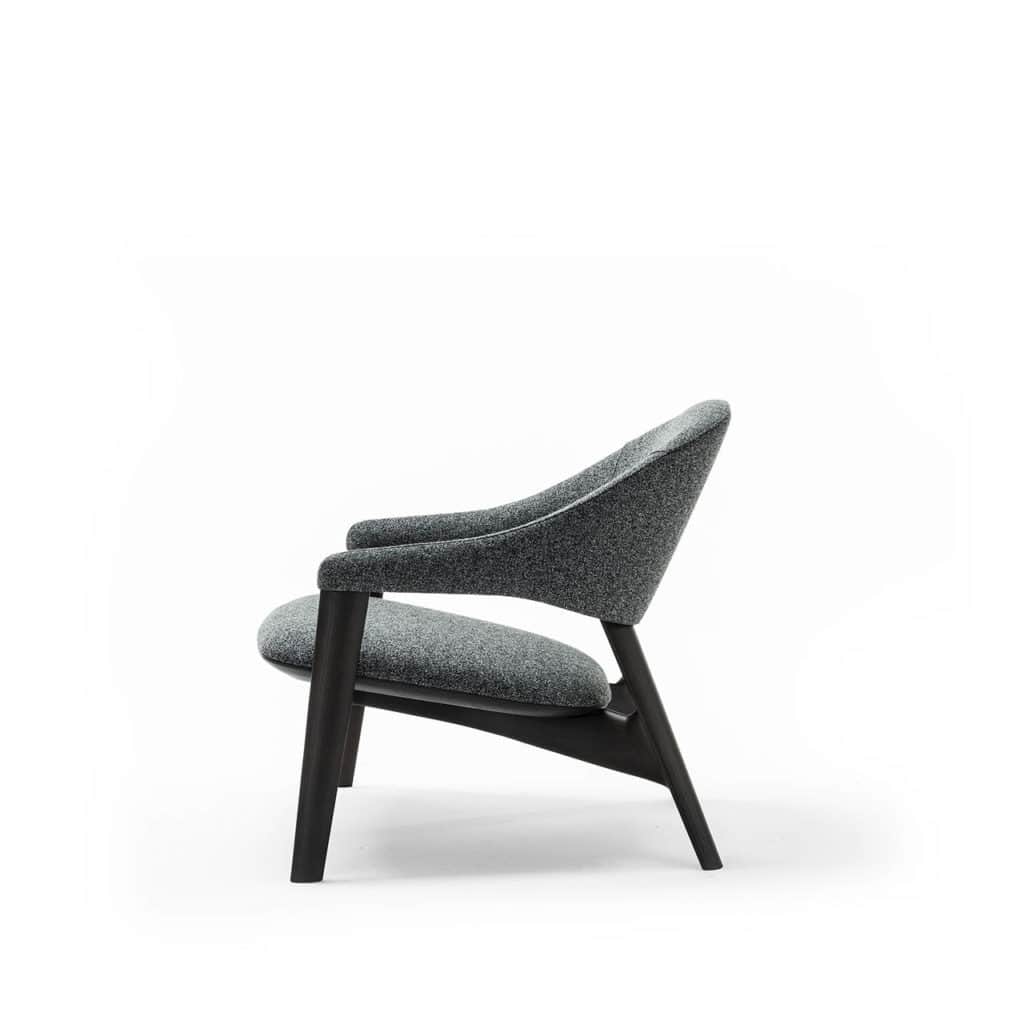 A modern armchair with a curved silhouette. The chair features a dark wooden frame and upholstered s… — free OBJ 3D model