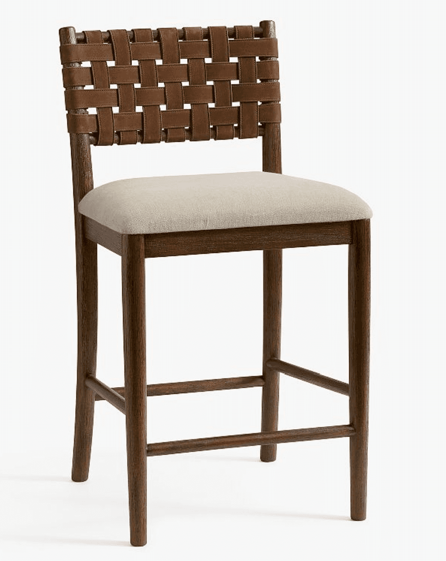 A bar stool featuring a dark wood frame, a woven brown leather backrest, and a light-colored upholst… — 3D model