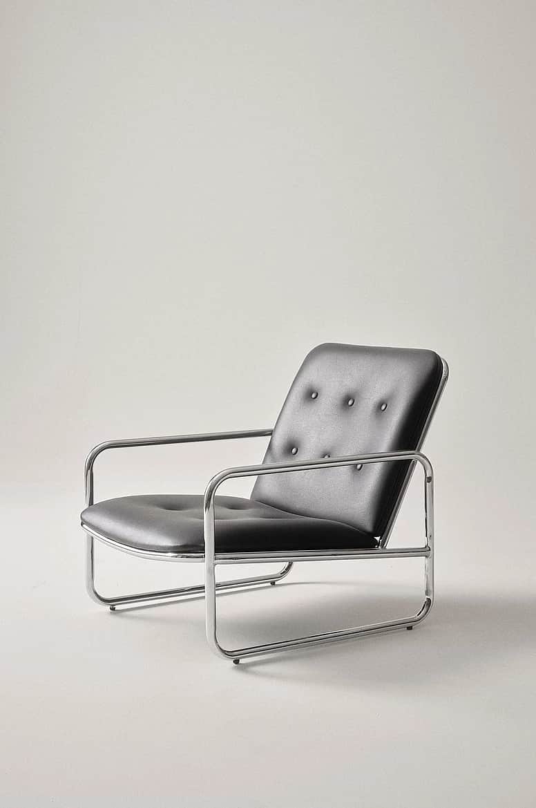 A modern tubular chrome armchair with black button-tufted faux leather cushions for the seat and bac… — 3D model