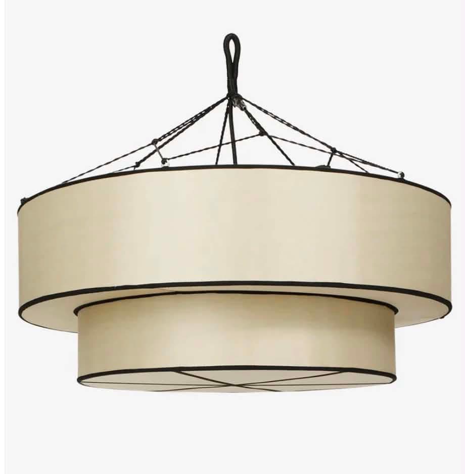 A two-tiered cylindrical light fixture with cream fabric shades and black contrasting trim, suspended by black cords from a central point. — 3D model
