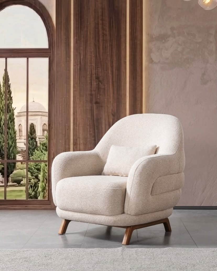 A modern upholstered armchair with a light-colored textured fabric and wooden legs, featuring rounde… — 3D model