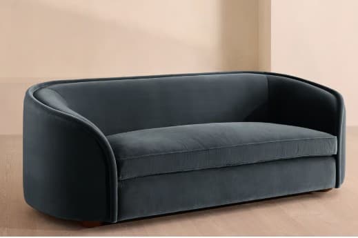 A modern two-seater loveseat, upholstered in a deep teal velvet, featuring a continuous curved back and integrated rounded arms, with a single bench seat cushion. — 3D model