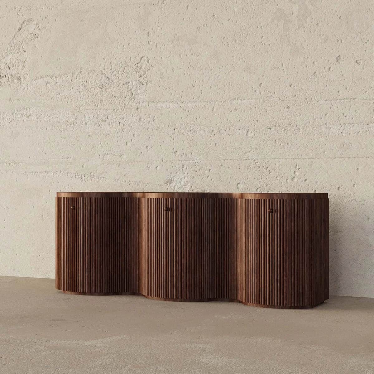 A long, low wooden storage unit featuring a distinctive wavy front composed of vertical reeded panel… — 3D model