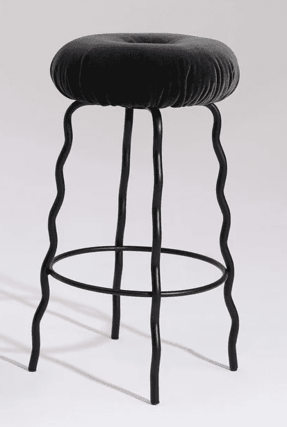 A modern bar stool featuring a deeply cushioned, round seat upholstered in dark grey velvet, disting… — 3D model