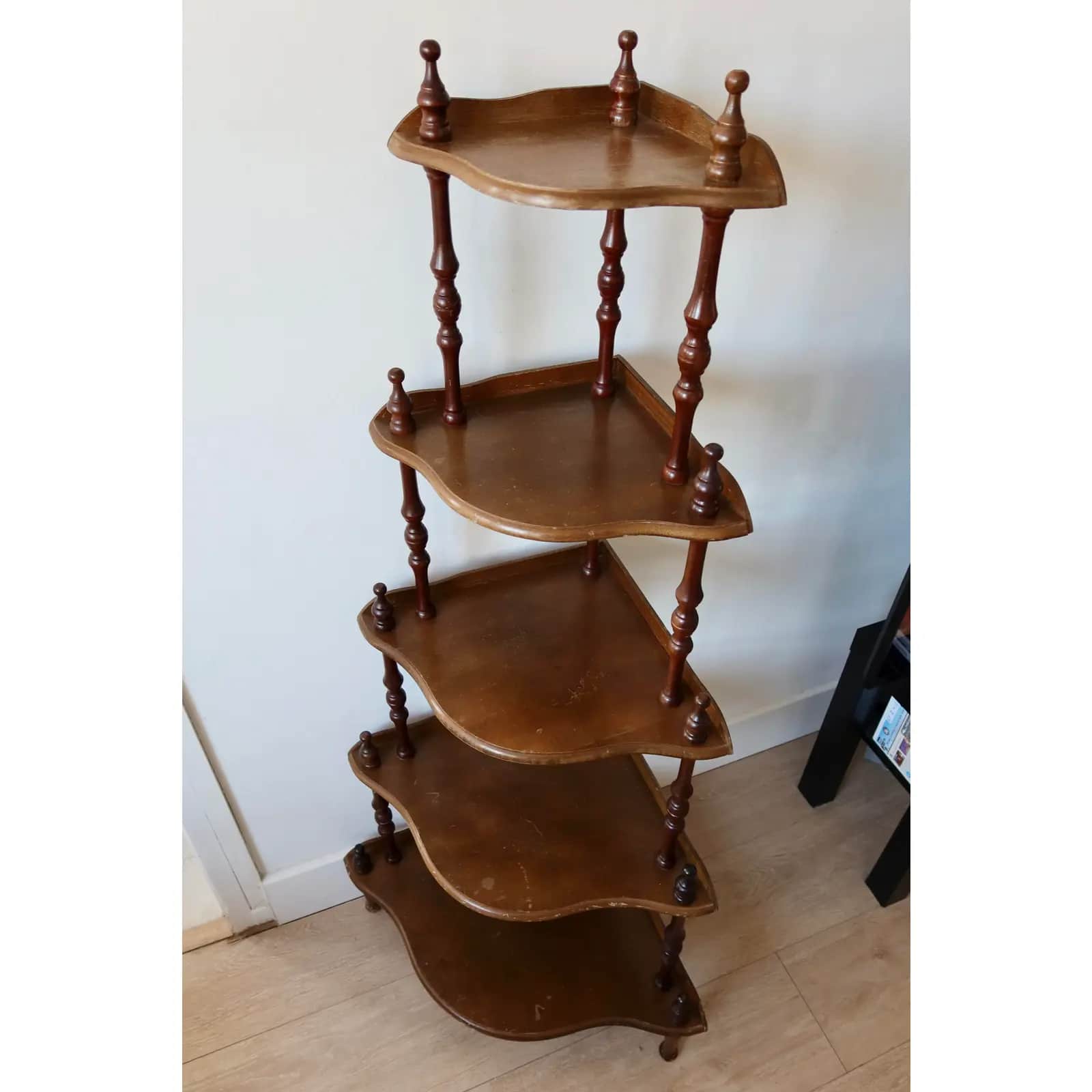 A wooden five-tier corner display shelf with turned spindle supports and decorative finials, designe… — 3D model