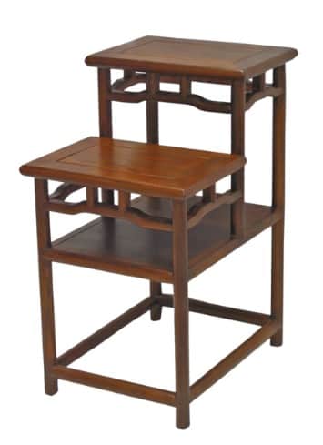 A dark brown wooden stepped display stand featuring two elevated rectangular surfaces and a lower sh… — 3D model