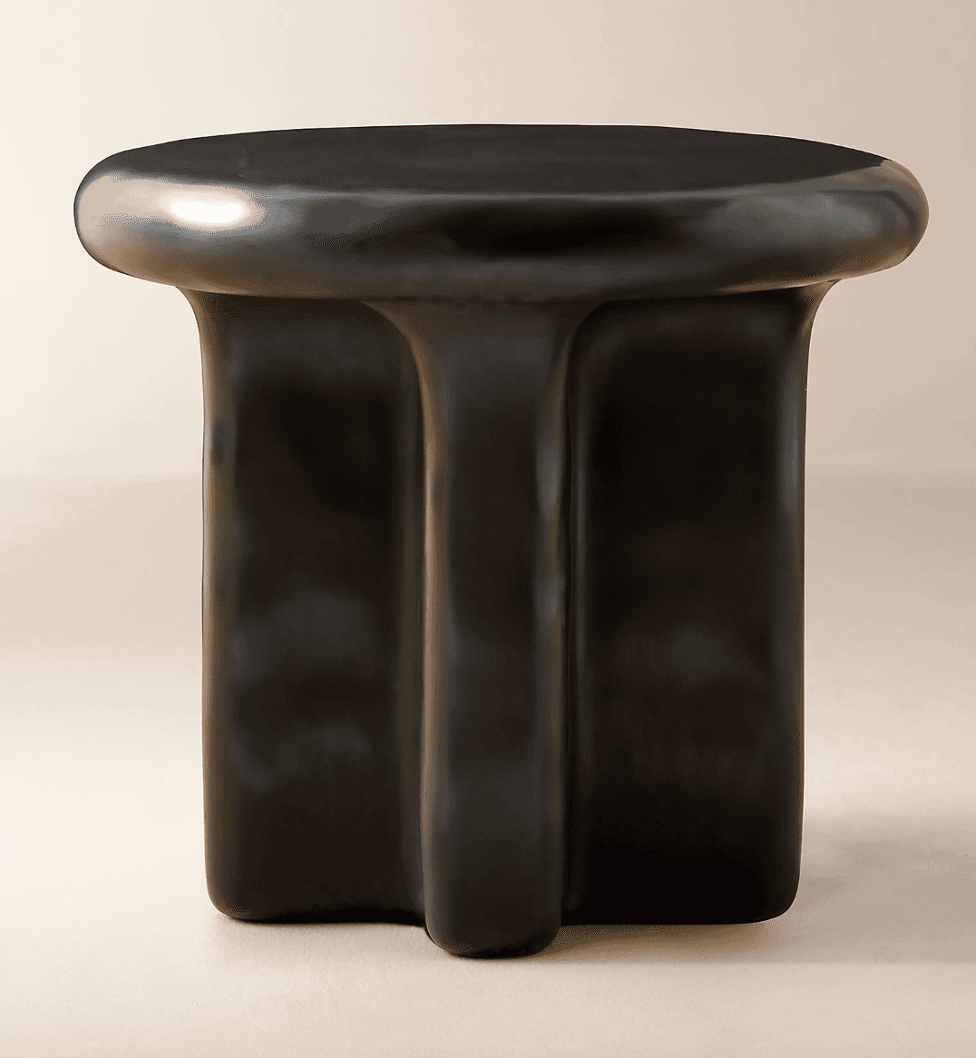 A modern side table with a rounded, irregular top and a sculpted base. The base appears to be formed… — 3D model