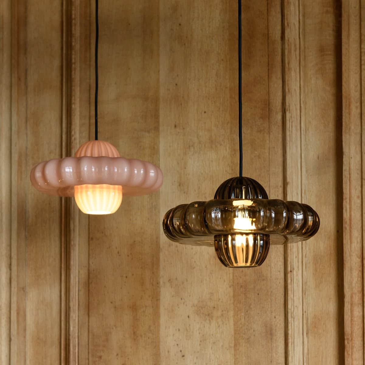 A pale pink pendant light featuring a distinctive ruffled, circular shade. The light hangs from a bl… — 3D model