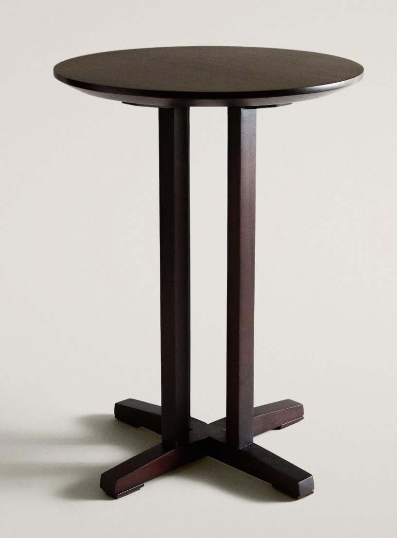 A tall, dark brown round bar table featuring a double pedestal base that converges into an X-shaped foot. The tabletop is circular and matches the deep, rich tone of the base. — 3D model