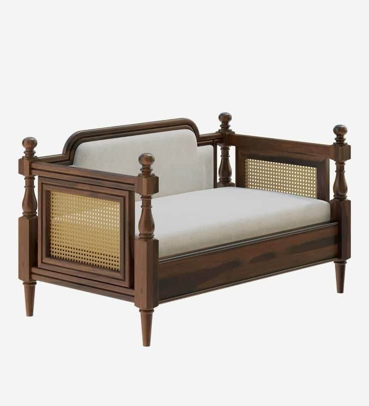A traditional colonial style daybed constructed from dark stained wood, featuring cane webbing panel… — 3D model